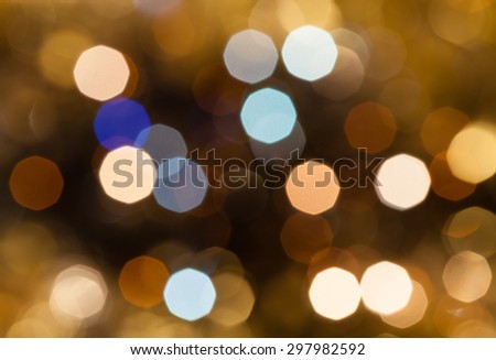 abstract blurred background - brown and pink shimmering Christmas lights bokeh of electric garlands on Xmas tree