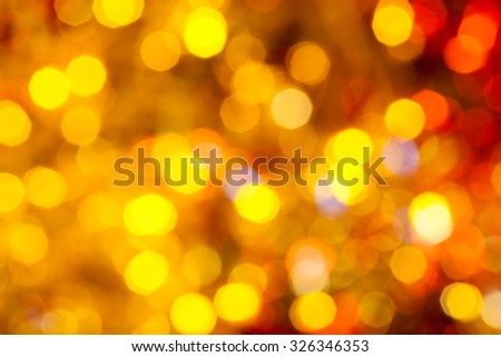 abstract blurred background - brown, yellow and red Christmas lights bokeh of electric garlands on Xmas tree