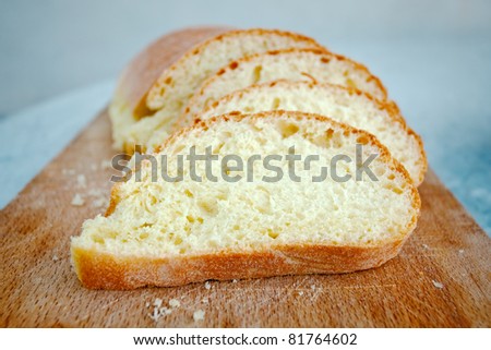 slices of sicilian semolina yellow bread on wooden board
