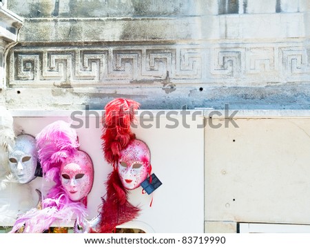 venetian carnival masks on old wall in Venice, Italy