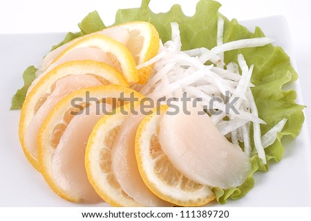 White fish with a lemon and salad on a white dish