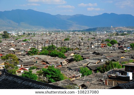 Ancient roof in Lijiang old town with Snow mountain background , Yunnan China