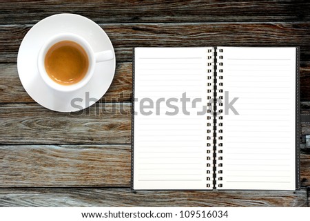 Blank book with coffee frame on wooden background