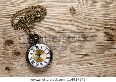 Antique watch on wooden background