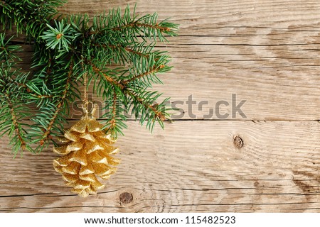 Golden pine cone on christmas tree