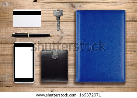 Everyday accessories and objects on wooden background