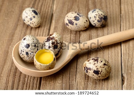 Quail eggs in wooden spoon