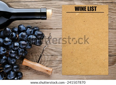 Bottle of wine, corkscrew, grape and blank wine list