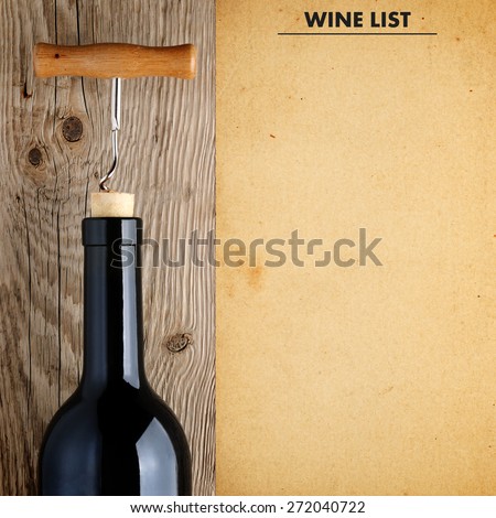 Bottle of wine with corkscrew and wine list