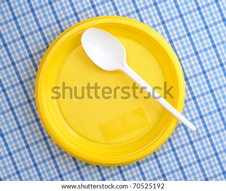Plastic plate and spoon on table