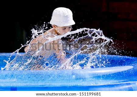 Kid making splashes in the pool