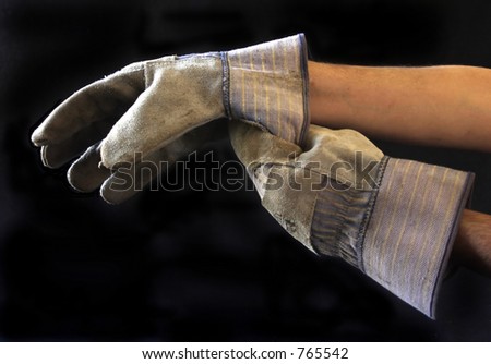 person putting on work gloves