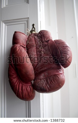 vintage boxing gloves hanging up on a hook