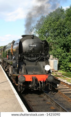 steam train in station in station waiting to depart