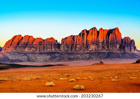 Jebel Qatar Mountain in Wadi Rum, Jordan at twilight. Wadi Rum is known as The Valley of the Moon and has led to its designation as a UNESCO World Heritage Site.