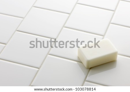 White soap bar on white tile floor