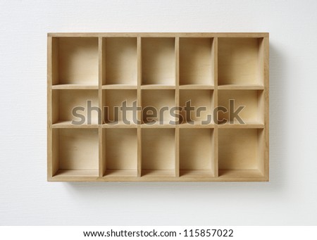 Empty wooden rack on white wall