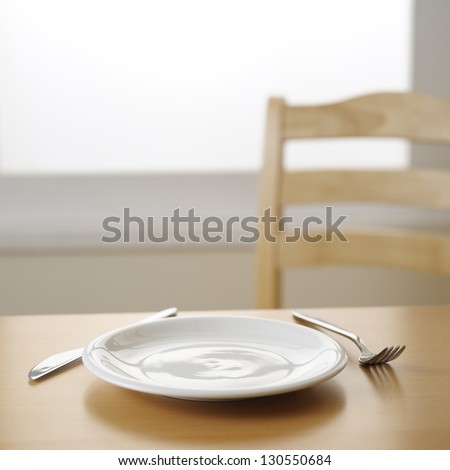 Empty Plate Knife And Fork On The Table