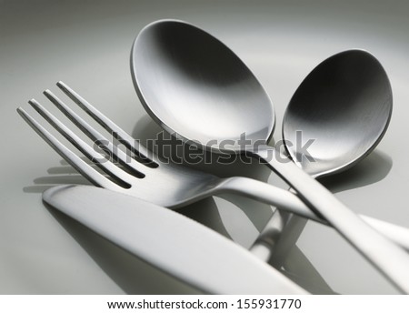 knife fork and spoon on white plate
