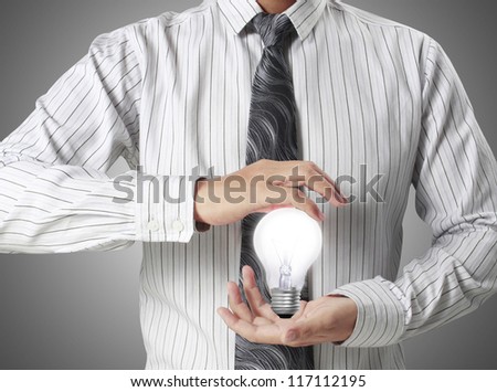 Light bulb in hand businessman