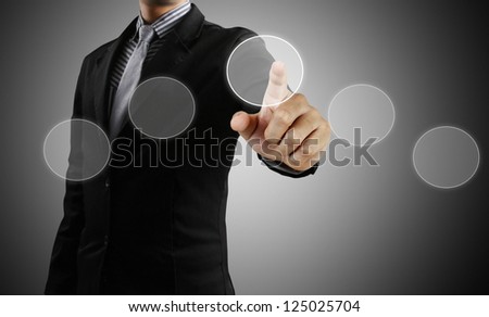 Business man pushing on a touch screen interface