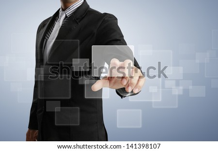 Business man pushing on a touch screen interface