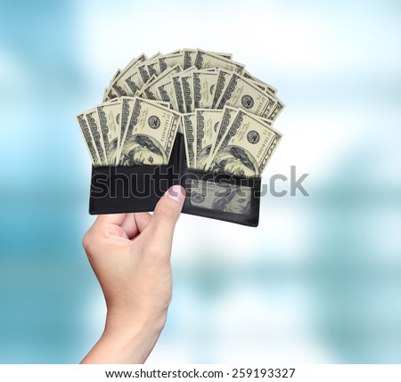 Closeup hands as he is getting a banknote out of his wallet