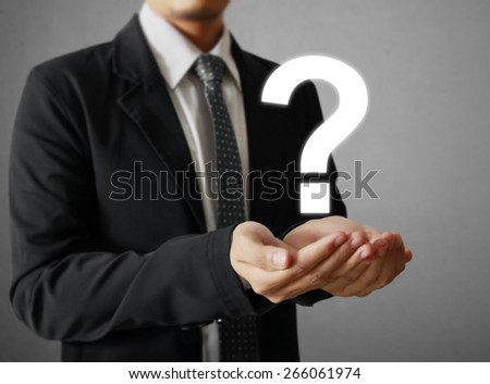 Business man holding question mark symbol