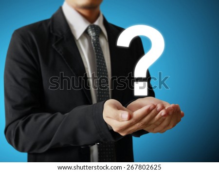 Business man holding question mark symbol