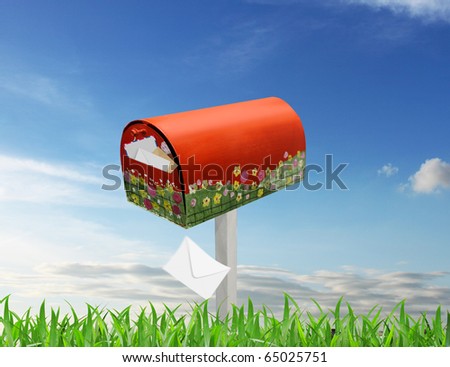 Red mail box in green garden