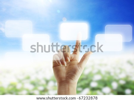 Beautiful hand pushing a button on a touch screen