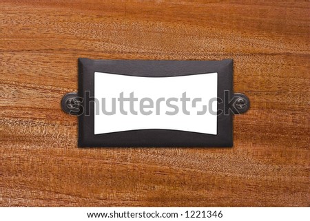 An old textured metal frame with screws on a wood background. Insert your own text or image.
