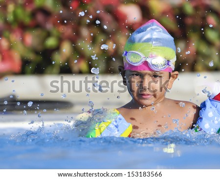 Indian South Asian origin boy having a good time in Arab resort swimming pool