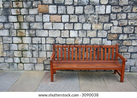 Isolated bench against concrete wall background