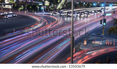 City intersection time lapse with traffic seen as trails of light