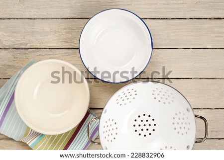 empty bowls and colander on wooden table