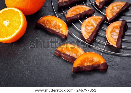 candied orange slices over black background