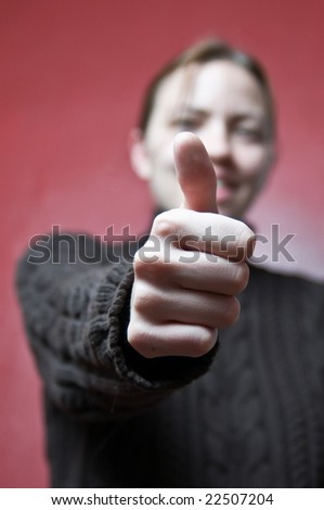 Young woman giving thumbs up sign