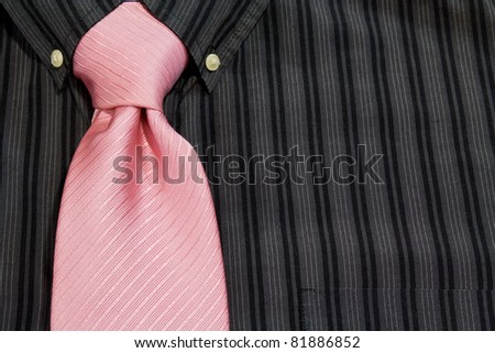 pink necktie tied on black pinstriped shirt