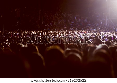 Large crowd of people watching concert or sport event