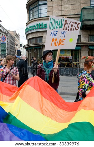 RIGA, LATVIA, MAY 16, 2009: Gay men and women and their supporters at parade in the Latvian capital, accompanied by a strong police presence and loud protest from anti-gay activists in Riga, Latvia, May 16, 2009.