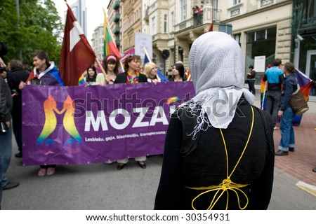 RIGA, LATVIA, MAY 16: Protesting woman against Gay, lesbian and their supporters at parade in the Latvian capital, accompanied by strong police presence and loud protest from anti-gay activists in Riga, Latvia on May 16, 2009