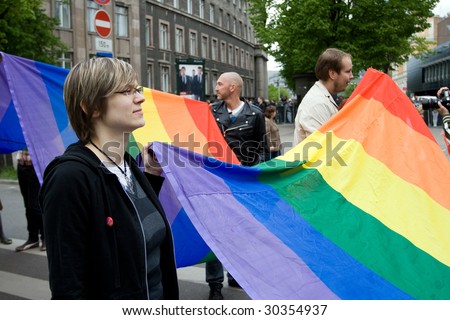RIGA, LATVIA, MAY 16: Gay men and women and their supporters at parade in the Latvian capital, accompanied by a strong police presence and loud protest from anti-gay activists in Riga, Latvia on May 16, 2009