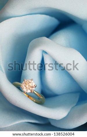 Solitaire engagement diamond ring (ideal cut) encrusted on 18K gold ring embedded in blue rose.