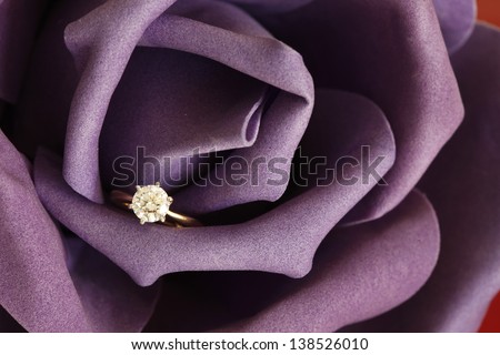 Solitaire engagement diamond ring (ideal cut) encrusted on 18K gold ring embedded in purple rose.