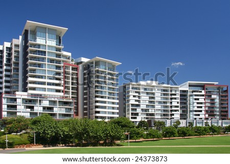 New apartments on blue background and green field