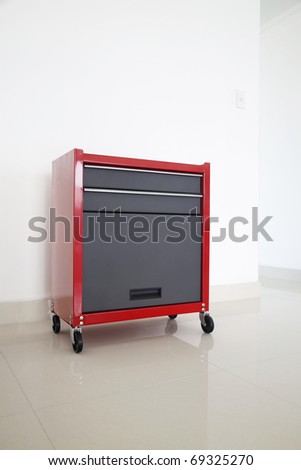 Red toolbox with chrome black door on white background