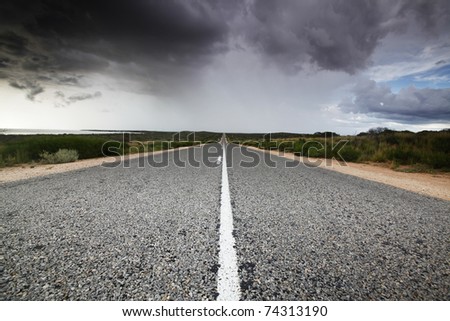 Road in Shark Bay, Western Australia (part of the World Heritage Drive). The distant rain and storm is visible.