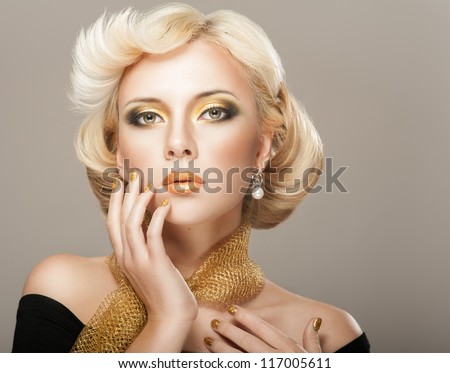 Beautiful woman face with luxury gold makeup Beautiful woman face with luxury gold makeup
