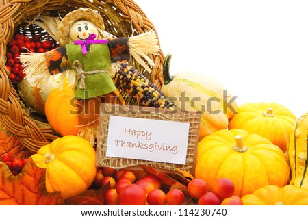 Happy Thanksgiving card and scarecrow among a cornucopia of autumn vegetables